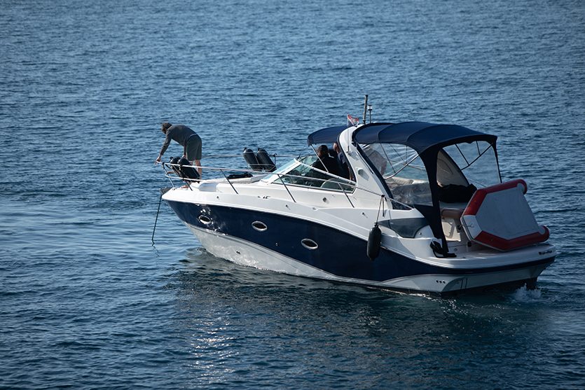 Navy and white boat underway on open water